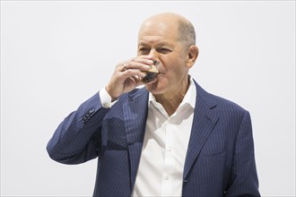 Olaf Scholz (Chancellor of the Federal Republic of Germany, SPD) drinks an espresso during a press