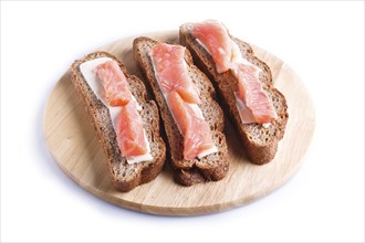 Smoked salmon sandwiches with butter on wooden board, isolated on white background. close up