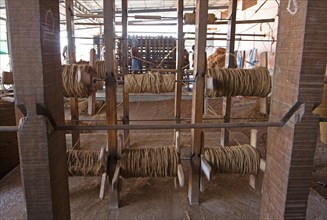 Coir fibre bobbins in the spinning mill of the Labourers Coir Mats and Mattings Cooperation, coir