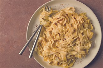 Fettuccine, tagliatelle, in creamy garlic sauce, Italian traditional cuisine, pasta carbonaro