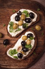 Breakfast, sandwiches, with cream cheese, olives, top view