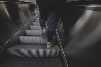 A man walks up an escalator in Berlin, 27/02/2024