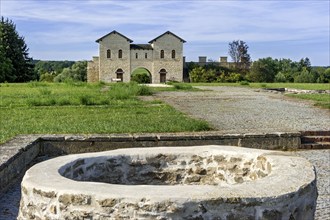 Biriciana Roman fort, fountain in the inner courtyard and reconstructed north gate, Porta decumana,