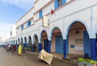 Historic buildings shops and hotel in arcaded shopping street in town centre, Mirleft, southern