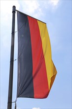 German national flag in front of a blue sky