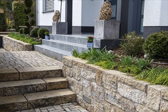 Well-kept front garden with block steps made of natural stone and granite