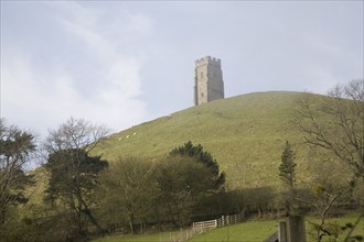 St Michael's Tower on Glastonbury Tor, Somerset, England in misty haze with blue sky