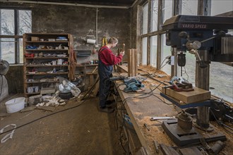 Young man builds a table in his workshop, Mecklenburg-Vorpommern, Germany, Europe