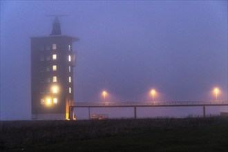 Thick fog in winter, hanging over the mouth of the Elbe into the North Sea, radar tower of the