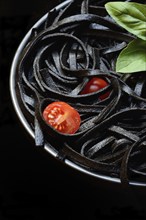 Black pasta coloured with squid ink on a plate, Taglioni al Nero di Seppia, Italy, Europe