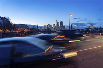 Skyline of the city centre of Frankfurt am Main, road traffic, car, on the raft bridge, dusk, river