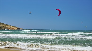 Kitesurfer glides with his kite over the waves of the sea, surfers paradise, kitesurfer,