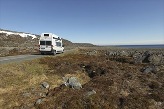 Campervan/caravan on a lonely coastal road through the tundra near Hamningberg on the Barents Sea,