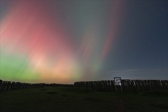 Northern lights (aurora borealis) over the ring sanctuary of Pömmelte, prehistoric circular ditch