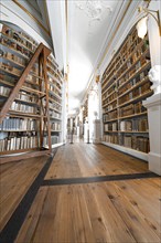 Long corridor with high bookshelves and wooden beams, creating a historical atmosphere, Weimar,