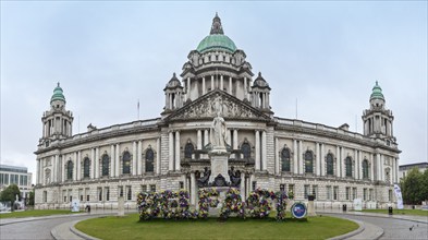 Neoclassical building with dome and statues surrounded by flowers in a historic style, Belfast