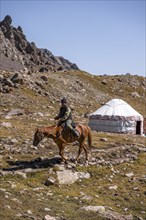 Rider and yurt in the high valley, Keldike Valley on the way to the Ala Kul Pass, Tien Shan