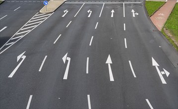 Road markings, turning lanes, directional signage at an intersection, turning, straight ahead,