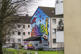 Housing estate, apartment buildings, colourful mural with local reference, music, 99 balloons, in