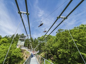 Rappbode water reservoir, suspension bridge Titan RT, two tourists 'flying' above the bridge on the