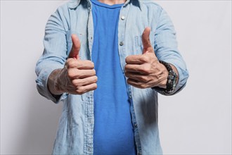 Person hands with thumbs up doing ok, Close up of man hands doing thumbs up, People with thumbs up