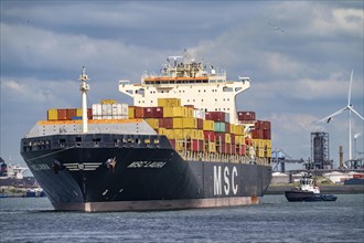 Europahaven, MSC Laura container freighter being towed by harbour tugs, seaport of Rotterdam,