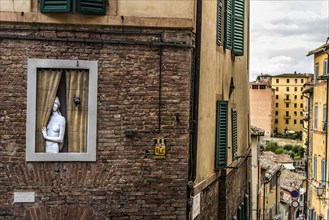 Sculpture in window, figure, gaze, looking, doll, art, representation, old town, alley, Siena,