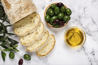 Appetizer, sliced ciabatta bread, with olive oil, green olives, Chalkidiki olives, classic Green