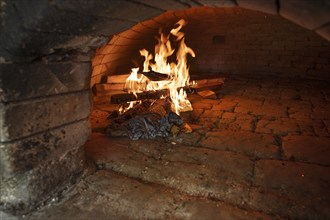 Wood fire in a baking oven in preparation for baking bread, baking oven festival in Franconia