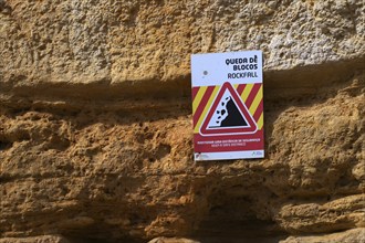 Rockfall, warning sign, danger of falling rocks, unstable cliff, beach, Praia da Dona Ana, Lagos,