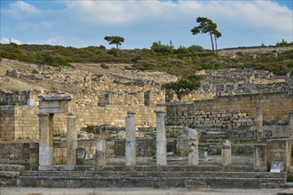 Ancient temple with half-ruined columns and stone structures in a natural setting, Well house,