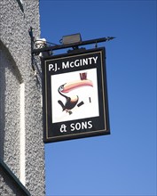 P.J McGinty Irish pub with toucan bird Guinness sign against blue sky, Ipswich, Suffolk, England,