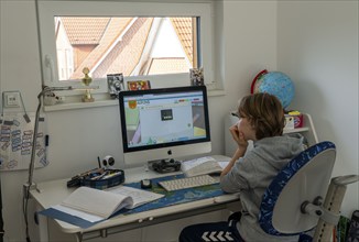 Young, primary school pupils, home learning, doing schoolwork, distance learning, virtual