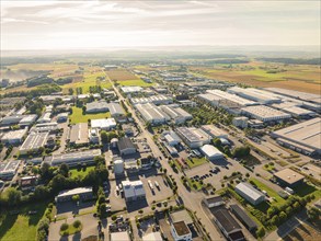 A bird's eye view of an industrial area with numerous factory buildings and neighbouring fields