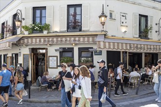 People enjoying coffee and company in a café in Montmartre, Paris