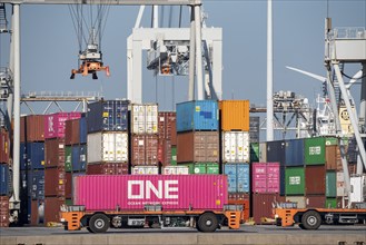 Self-driving, automated container transporters bring the containers to the loading and storage