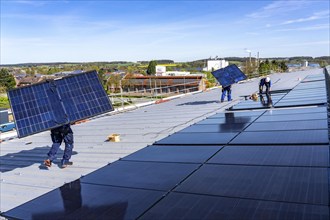 Installation of solar modules on the roof of a commercial enterprise, over 400 photovoltaic modules