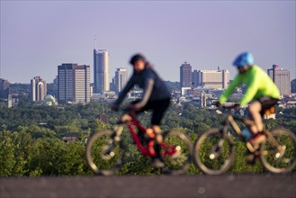 Skyline of Essen, city centre, skyscrapers, town hall, RWE tower, mountain bikers on the