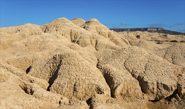 Dry mountain formations in a desert, clear blue sky shows a clear day, Bardenas Reales Natural