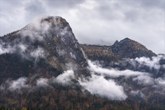 View of part of the Tennengebirge from Oberscheffau. The mountains are covered in clouds. Autumn.