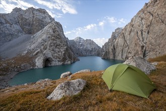 Wild camping, camping in the wilderness with a tent in front of mountain lake Kol Suu, Sary Beles