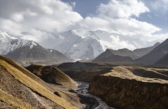 Achik Tash river, Achik Tash valley, behind glaciated and snow-covered mountain peak Pik Lenin,