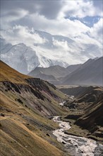 Achik Tash river, Achik Tash valley, behind glaciated and snow-covered mountain peak Pik Lenin,