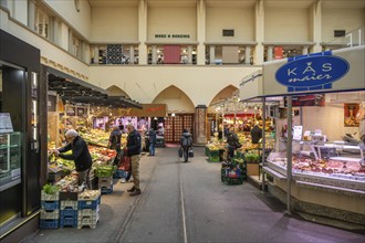 Various market stalls with supra-regional delicatessen goods in the Stuttgart market hall. The tram