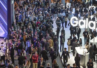 Visitors crowd the MWC Mobile World Congress 2024, Samsung exhibition stand, Barcelona, Spain,