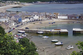 Coastal village with beach, boats and houses surrounded by hills, Stonehaven, Aberdeenshire,