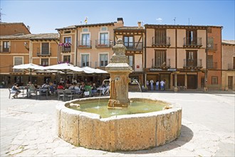 Fountain and traditional houses in the Plaza Mayor in the historic centre of Ayllon, province of