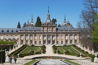 Historic palace with symmetrical formal garden and sculptures in sunny weather, Royal Castle La