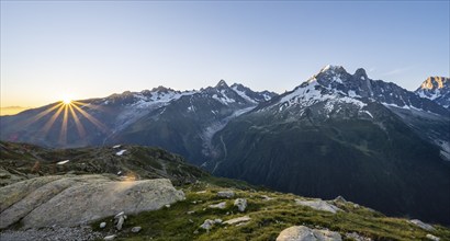 Morning atmosphere with sun star, mountain landscape at sunrise, mountain peak, Aiguille Verte,