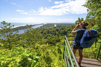 Tourist looking at the rainforest towards Cerro Tortuguero, Tortuguero National Park, Costa Rica,